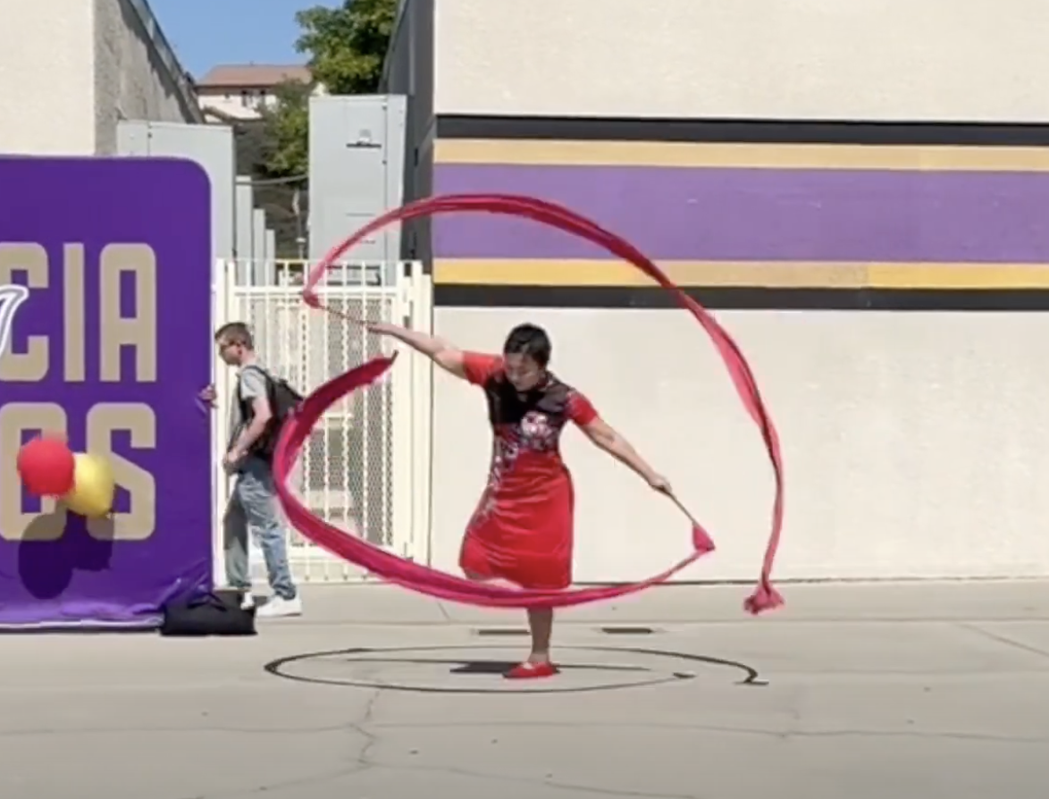 julie performs her famous long red ribbon twirling dance to welcome the new year