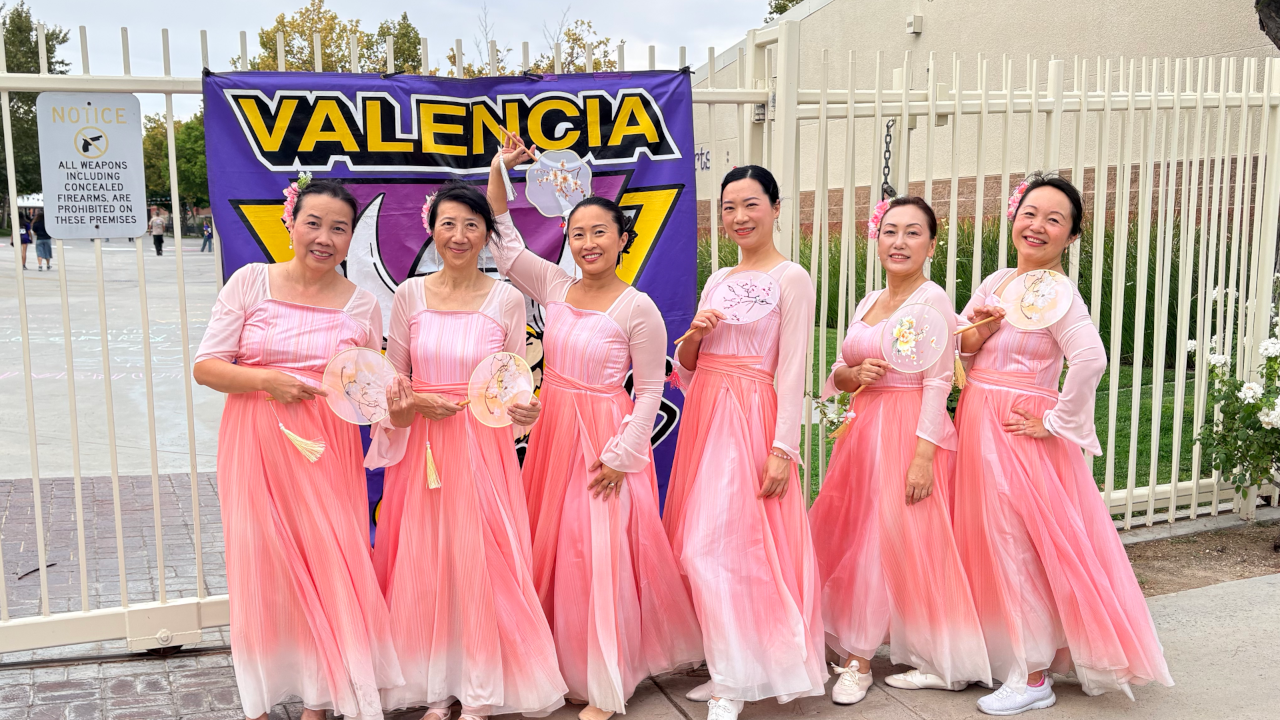 scv chinese dance posing at the front gate with their round fans