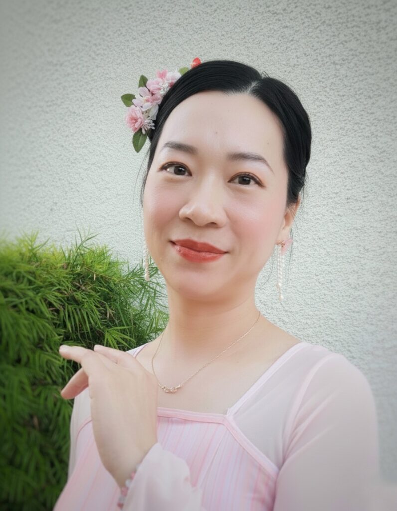 leader ting wearing a flower in her hair dressed in scv chinese dance's iconic pink dress