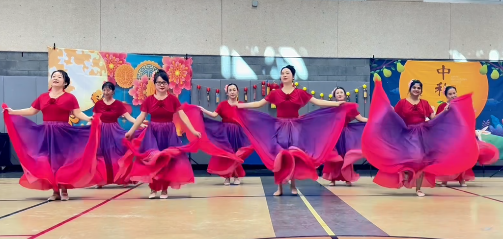 Strong wide shot of the red flowing-dress performance